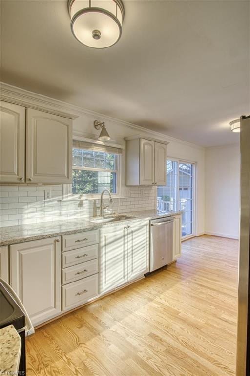 kitchen with decorative backsplash, dishwasher, light wood-type flooring, and sink