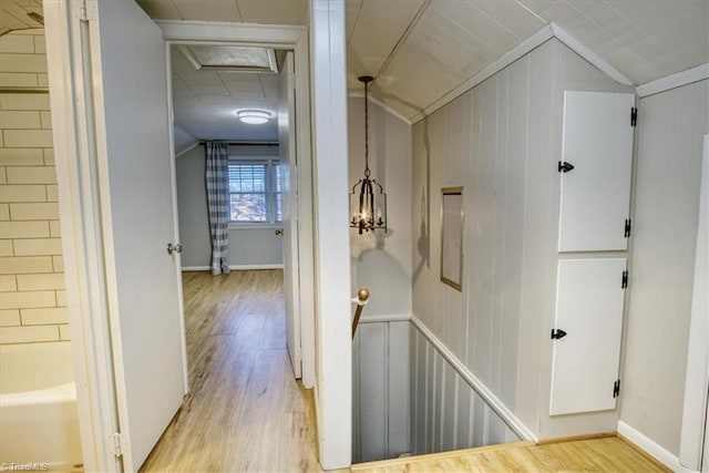 hall with light hardwood / wood-style floors and lofted ceiling