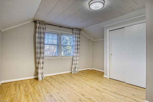 bonus room with light hardwood / wood-style floors and vaulted ceiling