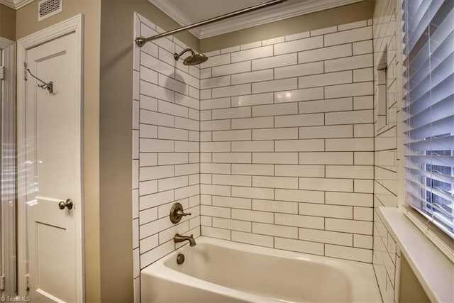 bathroom featuring ornamental molding and tiled shower / bath