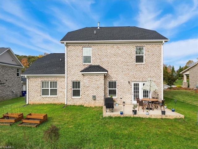 755 Gibb St, Winston-Salem, NC 27106 - back of property featuring a patio area, a lawn, a shingled roof, and brick siding