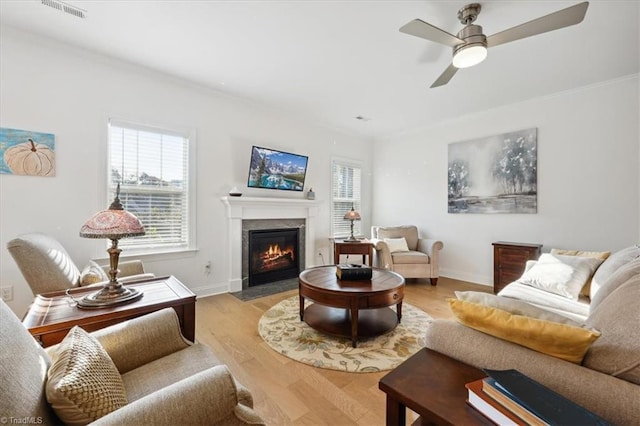 755 Gibb St, Winston-Salem, NC 27106 - living room with plenty of natural light, a ceiling fan, a fireplace with flush hearth, light wood finished floors, and ornamental molding