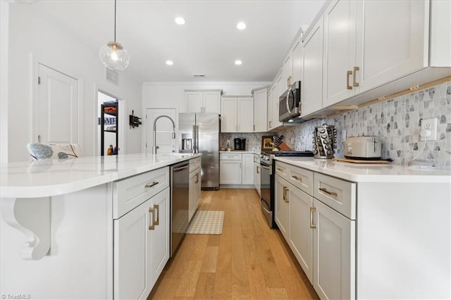755 Gibb St, Winston-Salem, NC 27106 - kitchen with stainless steel appliances, light wood-type flooring, light countertops, backsplash, and hanging light fixtures