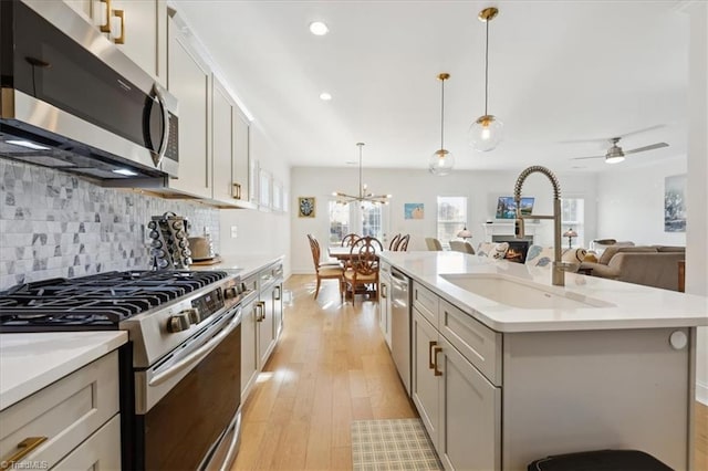 755 Gibb St, Winston-Salem, NC 27106 - kitchen with appliances with stainless steel finishes, light countertops, a chandelier, decorative backsplash, and recessed lighting