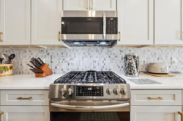 755 Gibb St, Winston-Salem, NC 27106 - kitchen featuring stainless steel appliances, light countertops, tasteful backsplash, and white cabinets