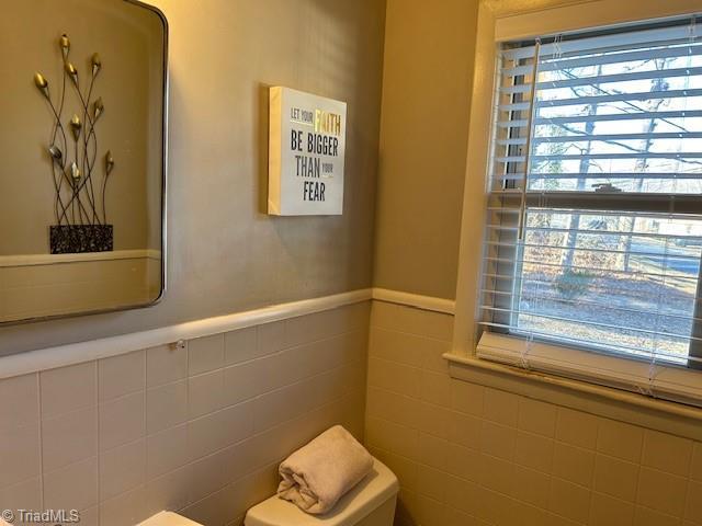 bathroom with tile walls