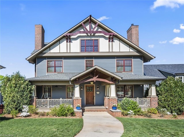 239 Glade View Ct, Winston-Salem, NC 27101 - view of front of house with a chimney, a porch, a front lawn, and board and batten siding