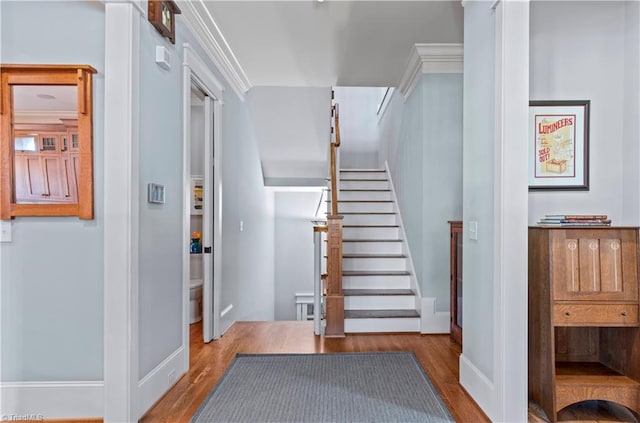 stairs with baseboards and wood finished floors