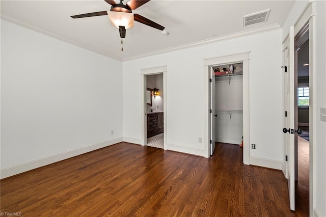 239 Glade View Ct, Winston-Salem, NC 27101 - unfurnished bedroom with wood finished floors, ornamental molding, baseboards, a walk in closet, and a closet