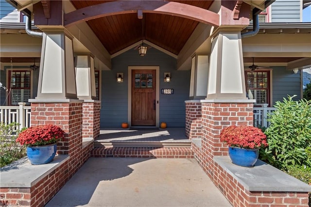 entrance to property featuring covered porch and ceiling fan