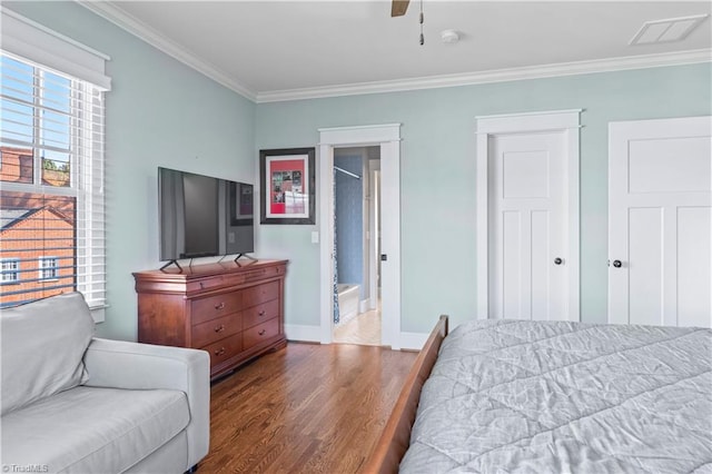 bedroom with dark wood-style flooring, crown molding, visible vents, ceiling fan, and baseboards