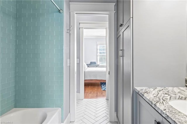 bathroom with ensuite bath, shower / bathing tub combination, and vanity