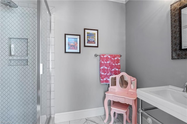 full bath featuring a sink, marble finish floor, a shower stall, and baseboards