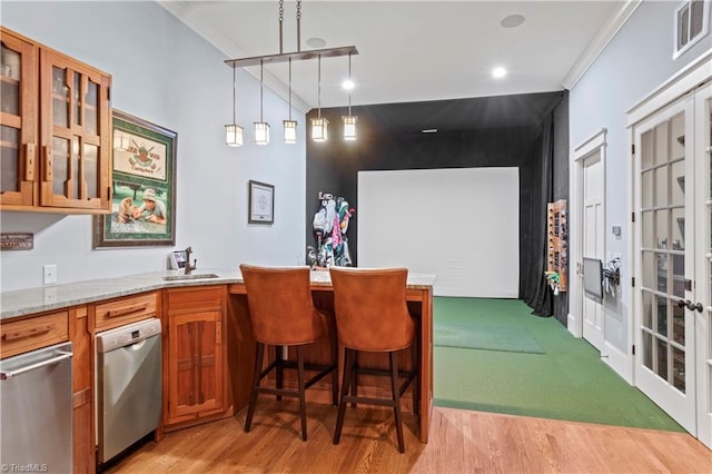 bar featuring light wood-style floors, pendant lighting, visible vents, and ornamental molding