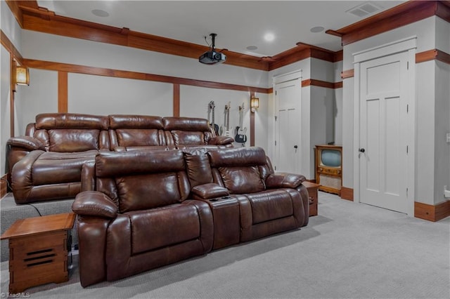 home theater with light carpet, baseboards, visible vents, and ornamental molding