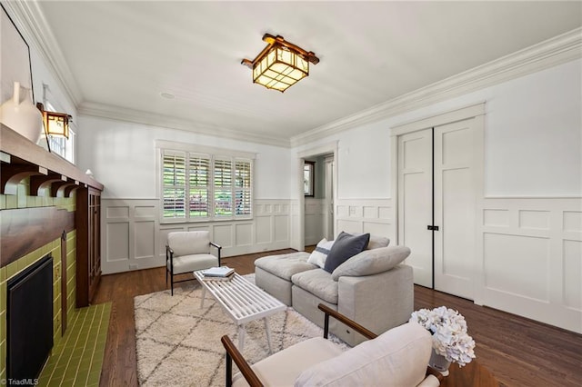 239 Glade View Ct, Winston-Salem, NC 27101 - living room with a tile fireplace, crown molding, dark wood-style flooring, a wainscoted wall, and a decorative wall