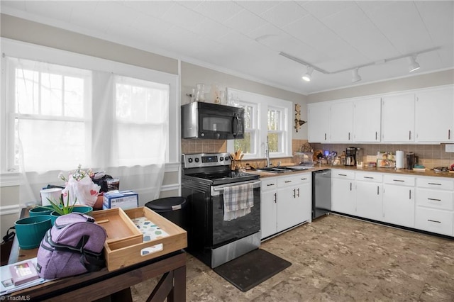 kitchen with backsplash, rail lighting, white cabinets, and appliances with stainless steel finishes