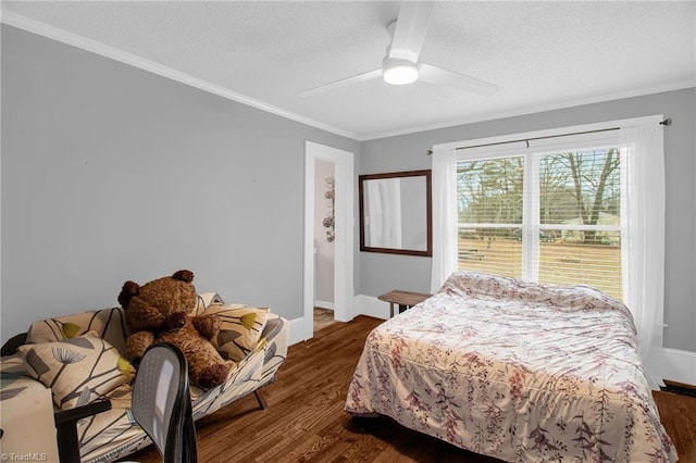 bedroom featuring crown molding, ceiling fan, dark hardwood / wood-style floors, and a textured ceiling