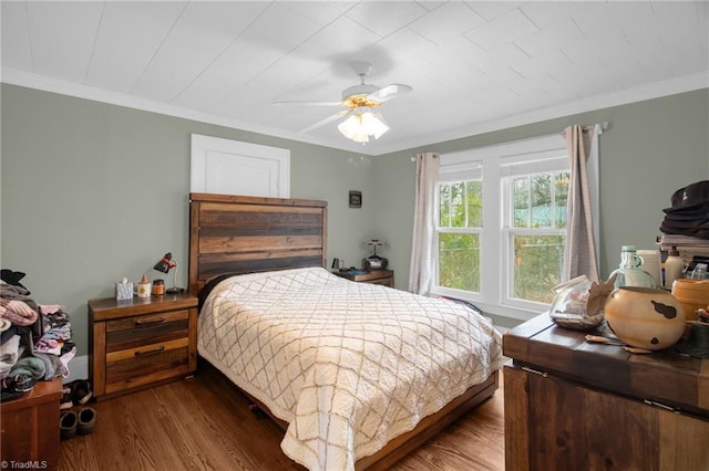 bedroom with wood-type flooring, ornamental molding, and ceiling fan