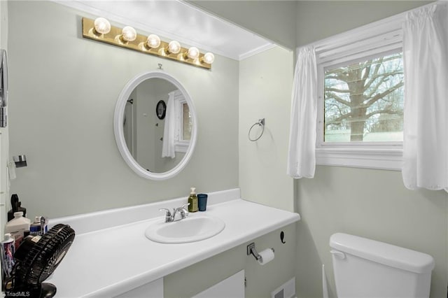 bathroom featuring vanity and toilet