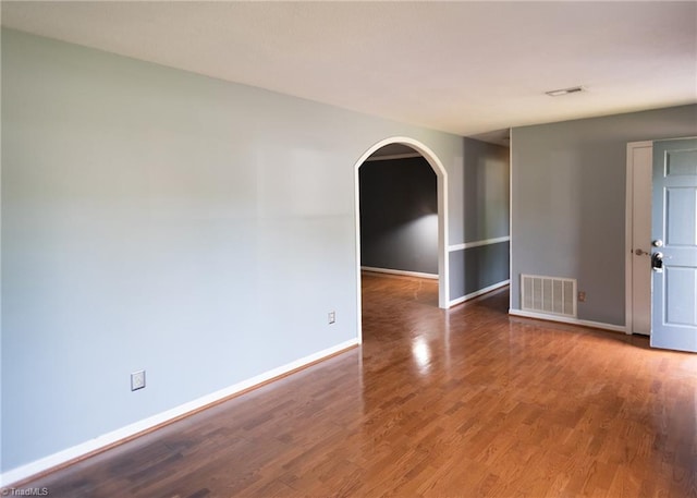 3607 Stonehurst Pl, High Point, NC 27265 - spare room featuring baseboards, arched walkways, and visible vents