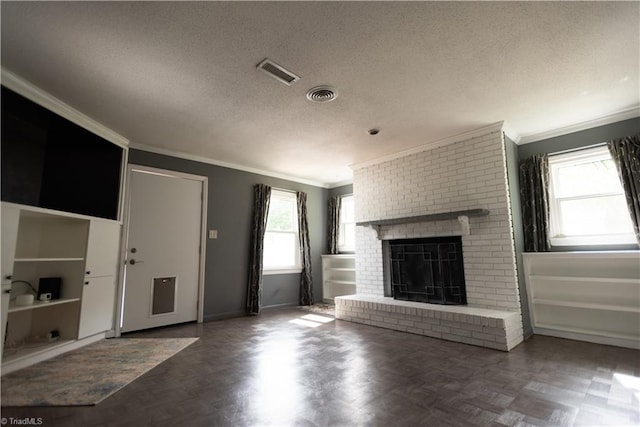 3607 Stonehurst Pl, High Point, NC 27265 - unfurnished living room featuring a brick fireplace, a textured ceiling, visible vents, and ornamental molding