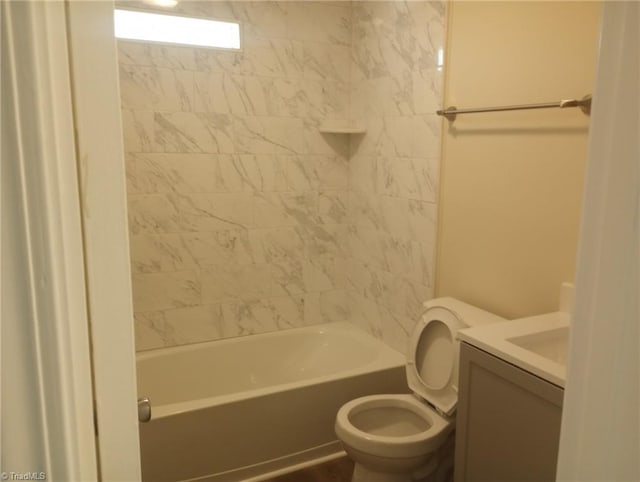 full bathroom featuring toilet, tiled shower / bath combo, and vanity