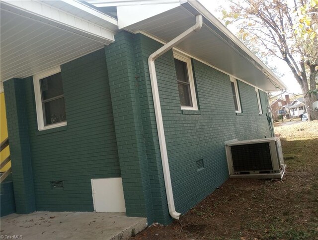 view of side of home with central AC