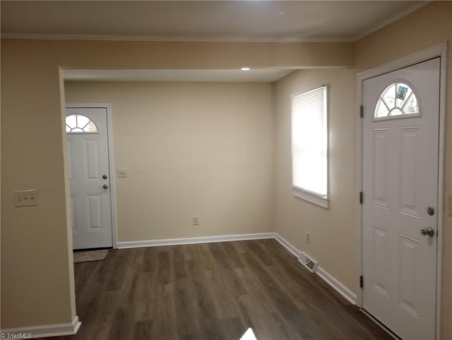 entrance foyer featuring dark hardwood / wood-style flooring and ornamental molding