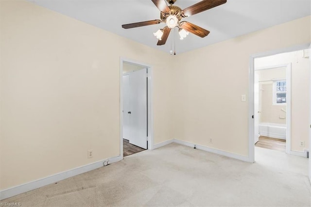 unfurnished bedroom featuring carpet flooring, ensuite bathroom, and ceiling fan