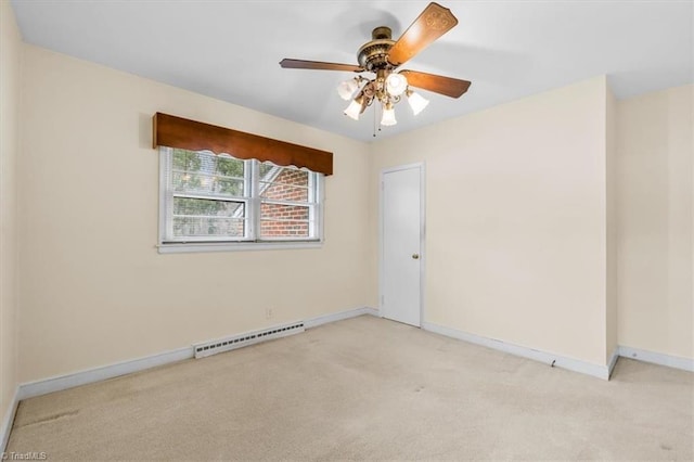 carpeted empty room with a baseboard radiator and ceiling fan