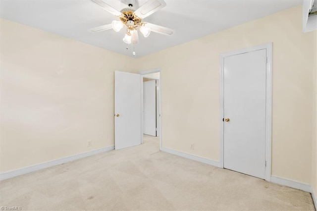 unfurnished bedroom featuring light carpet and ceiling fan