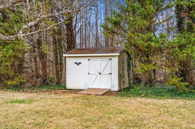 view of outdoor structure featuring a lawn