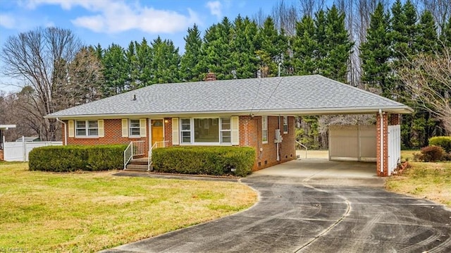 single story home with an outbuilding, a front lawn, and a garage