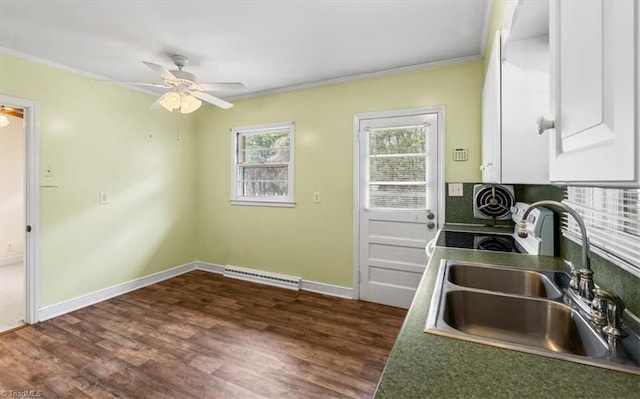 kitchen featuring white cabinetry, sink, ceiling fan, dark hardwood / wood-style flooring, and ornamental molding