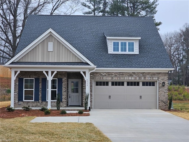 6036 Haywood St, Clemmons, NC 27012 - craftsman house featuring a porch, driveway, a shingled roof, and board and batten siding