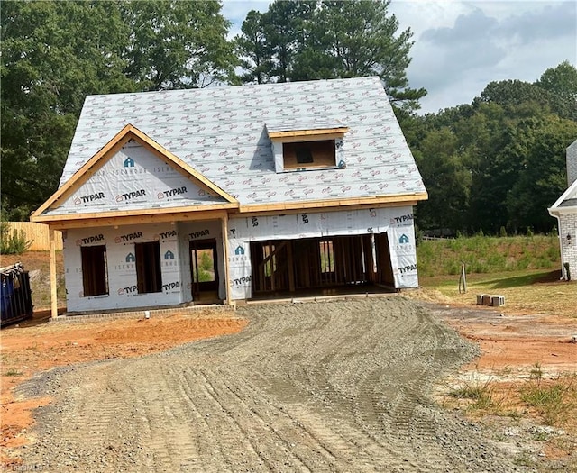 property under construction with dirt driveway