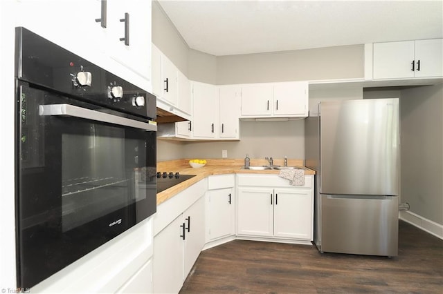 2904 Spring Garden St, Greensboro, NC 27403 - kitchen featuring black appliances, light countertops, dark wood-style flooring, white cabinets, and under cabinet range hood