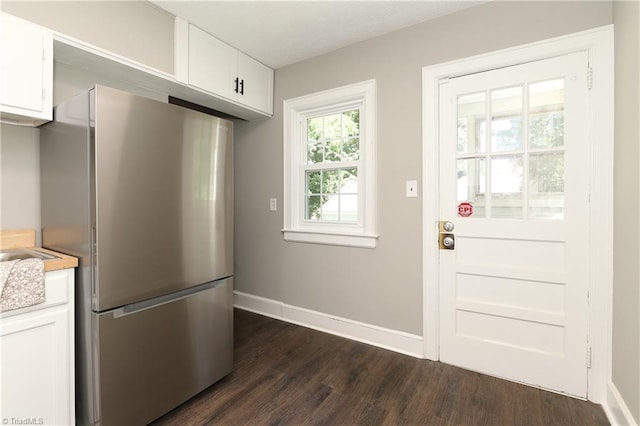 2904 Spring Garden St, Greensboro, NC 27403 - kitchen with freestanding refrigerator, dark wood-style flooring, white cabinetry, and light countertops