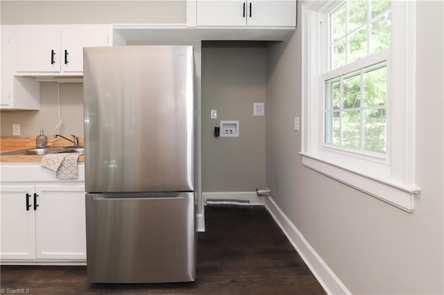2904 Spring Garden St, Greensboro, NC 27403 - kitchen with freestanding refrigerator, white cabinets, and dark wood-style floors