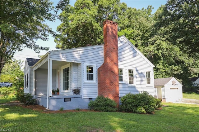 2904 Spring Garden St, Greensboro, NC 27403 - view of property exterior featuring a lawn, an attached garage, a chimney, an outbuilding, and crawl space
