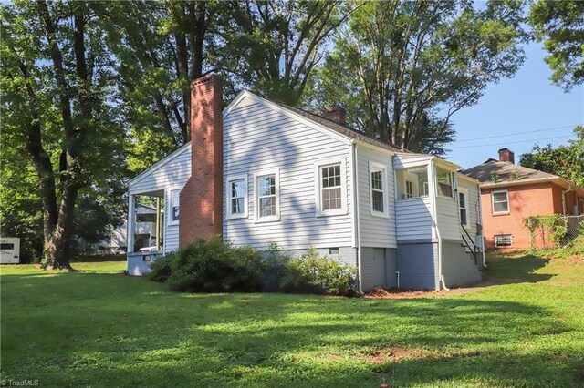 2904 Spring Garden St, Greensboro, NC 27403 - view of home's exterior featuring a chimney and a yard