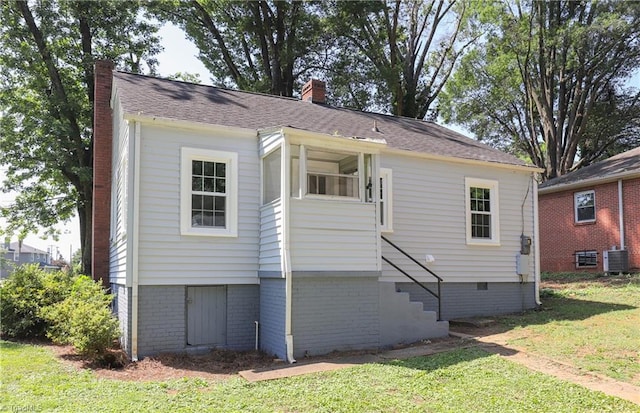 2904 Spring Garden St, Greensboro, NC 27403 - rear view of property featuring a chimney, a lawn, stairway, and brick siding