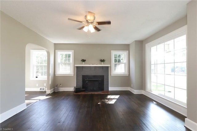 2904 Spring Garden St, Greensboro, NC 27403 - unfurnished living room featuring healthy amount of natural light, hardwood / wood-style flooring, ceiling fan, and a brick fireplace