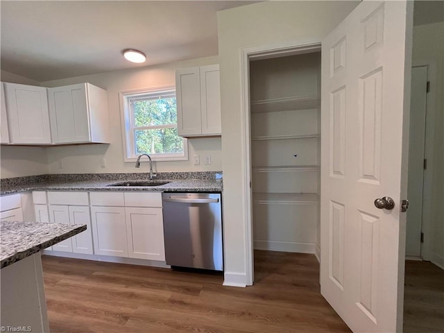 1609 Hardie St, Greensboro, NC 27403 - kitchen featuring stainless steel dishwasher, white cabinets, and wood finished floors