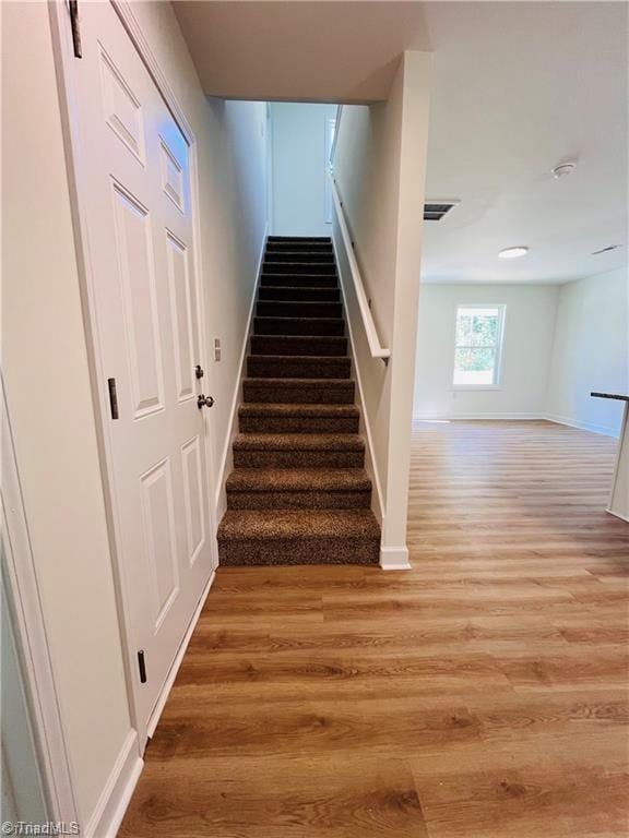 1609 Hardie St, Greensboro, NC 27403 - staircase featuring wood finished floors and baseboards