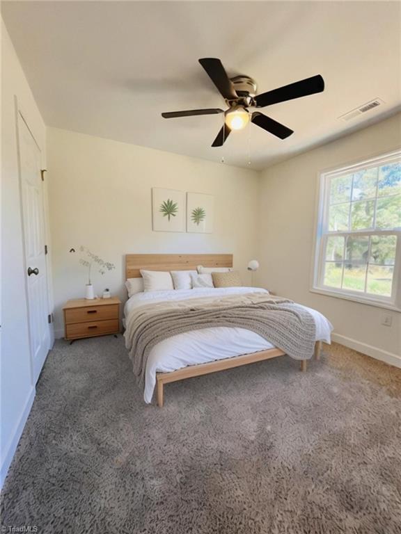 1609 Hardie St, Greensboro, NC 27403 - carpeted bedroom with baseboards and a ceiling fan