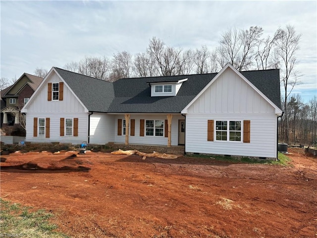 modern farmhouse style home with a shingled roof, crawl space, board and batten siding, and central air condition unit