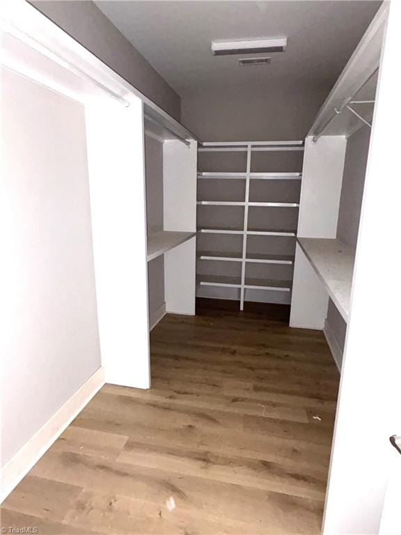 spacious closet with wood finished floors