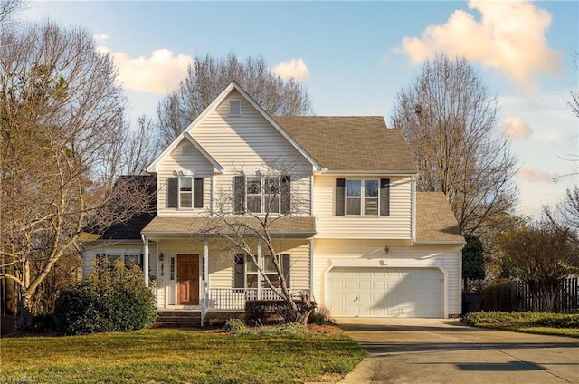 traditional-style home with concrete driveway, an attached garage, covered porch, and a front lawn